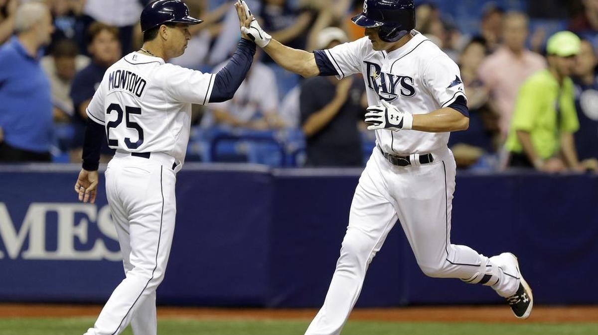 
Rays third base coach Charlie Montoyo, left, is high-fived by Mikie Mahtook after Mahtook’s home run against Miami on Sept. 29. It has been reported Montoyo has interviewed with the Mariners for the open manager position.
