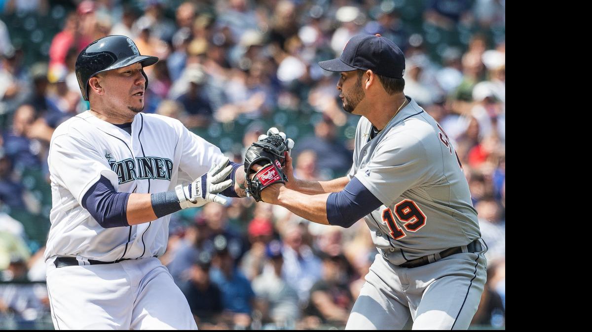 
The Mariners’ Jesus Sucre, left, is tagged out by Tigers pitcher Anibal Sanchez after bunting Brad Miller to second base during the sixth inning Wednesday at Safeco Field. It was one of two sacrifice bunts by Sucre.
