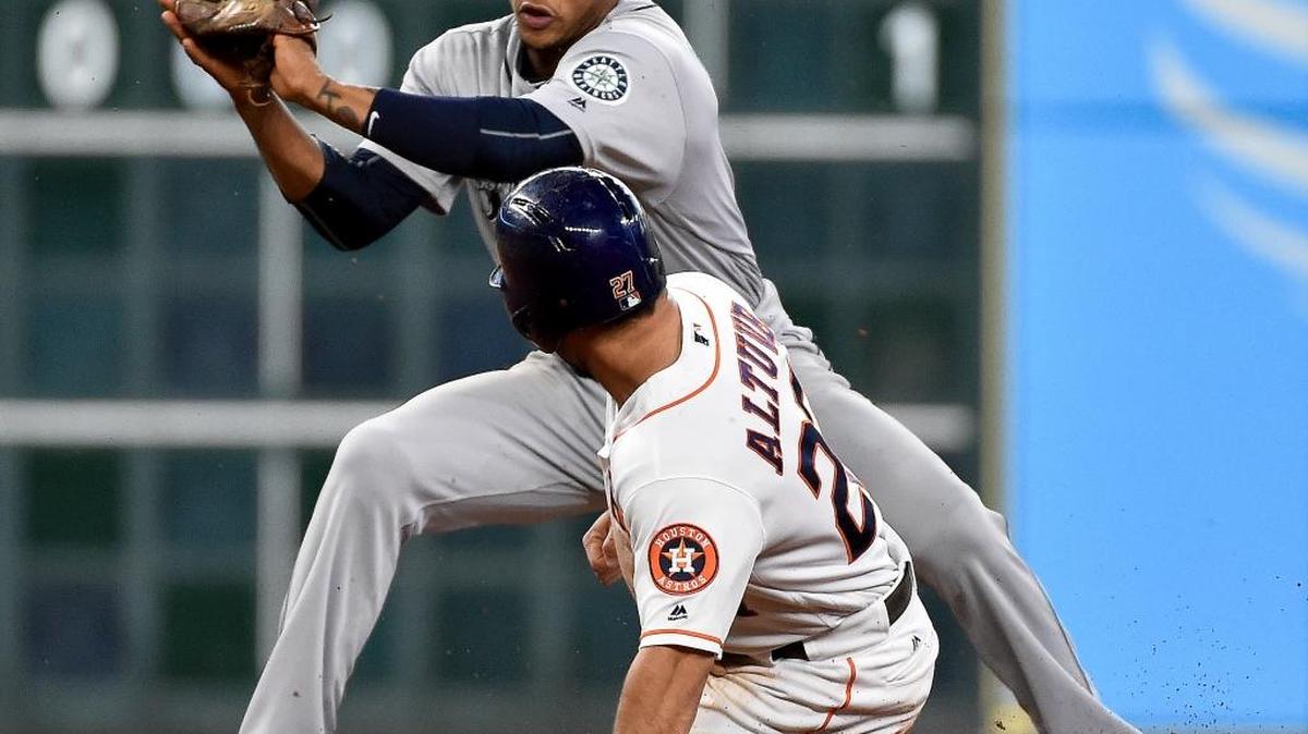 The Astros’ Jose Altuve steals second base ahead of Mariners shortstop Ketel Marte’s tag during the fourth inning of Tuesday’s game in Houston.