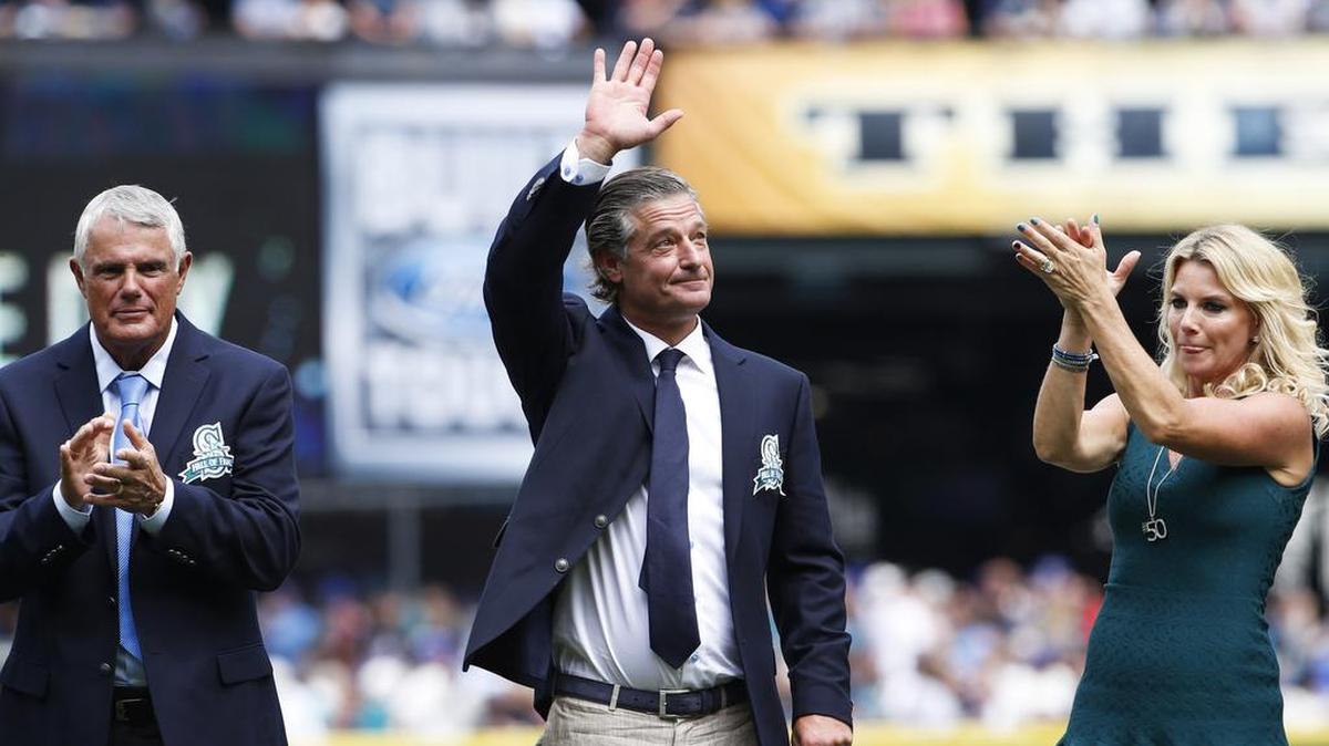 
Former Seattle Mariners pitcher Jamie Moyer, flanked by former Seattle manager Lou Piniella, left, and Moyer’s wife, Karen, waves to the crowd as he is inducted into the Mariners Hall of Fame.
