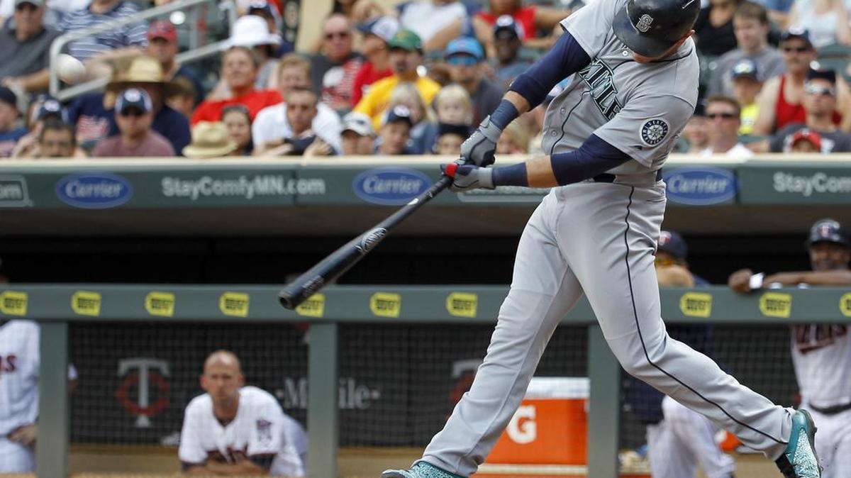 
The Mariners' Logan Morrison hits an RBI double to right field off Twins relief pitcher Brian Duensing in the 11th inning.
