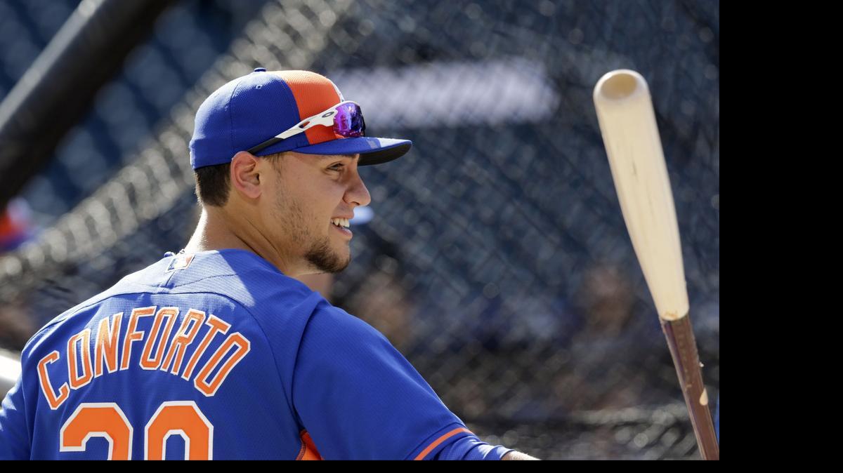 
Former Redmond High baseball and football standout Michael Conforto warms up Friday before his major league debut with the New York Mets. 
