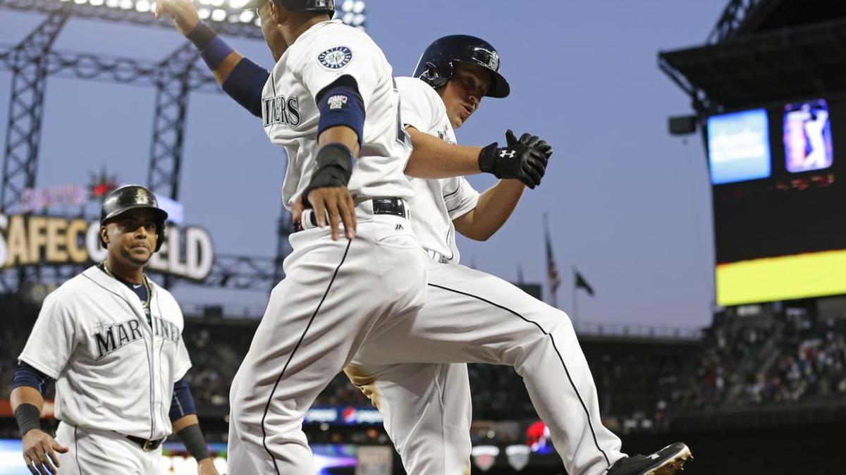 Seattle Mariners Kyle Seager, right, celebrates with teammates Robinson Cano, and Nelson Cruz, left, after Seager hit a three-run home run to score Cano and Cruz in the fourth inning of a baseball game against the New York Yankees, Monday, Aug. 22, 2016, in Seattle.