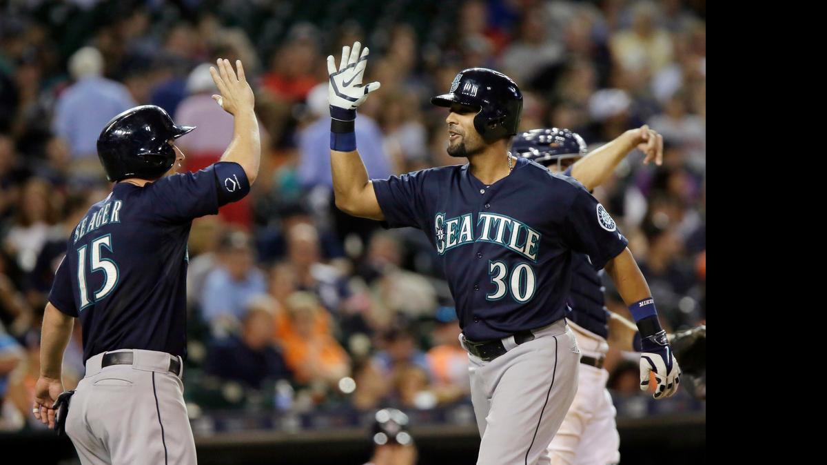 
Seattle Mariners’ Franklin Gutierrez (30) celebrates with Kyle Seager (15) after hitting a grand slam in the eighth inning Tuesday in Detroit.
