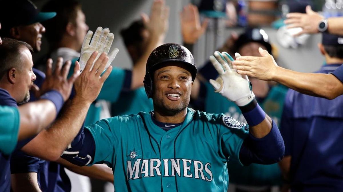 Seattle Mariners second baseman Robinson Cano is congratulated on his home run against the Milwaukee Brewers in a baseball game Friday, Aug. 19, 2016, in Seattle.