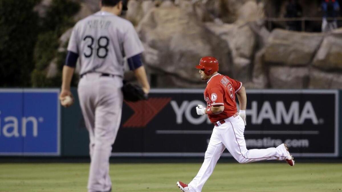 
Seattle Mariners starting pitcher Vidal Nuno, left, looks down as Los Angeles Angels' Albert Pujols rounds the bases after a two run, home run during the first inning of a baseball game in Anaheim, Calif., Friday, Sept. 25, 2015.
