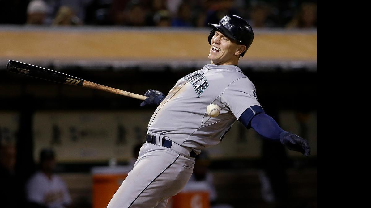 
Seattle Mariners' Logan Morrison reacts after being hit by a pitch from Oakland Athletics pitcher Scott Kazmir during the eighth inning of a baseball game in Oakland, Calif., Thursday, July 2, 2015. 

