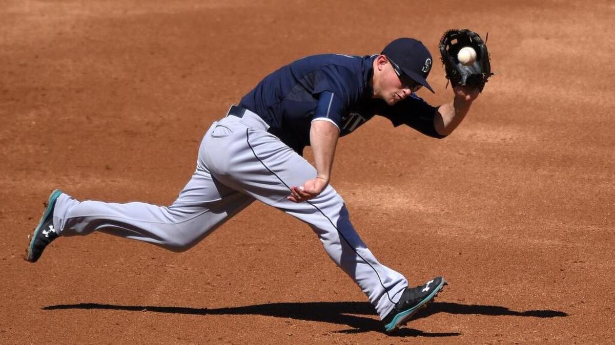 
Seattle Mariners third baseman Kyle Seager fields a ball hit by Johnny Giavotella of the Los Angeles Angels during the third inning Sunday in Anaheim, Calif. Seager threw out Giavotella at first base on the play.

