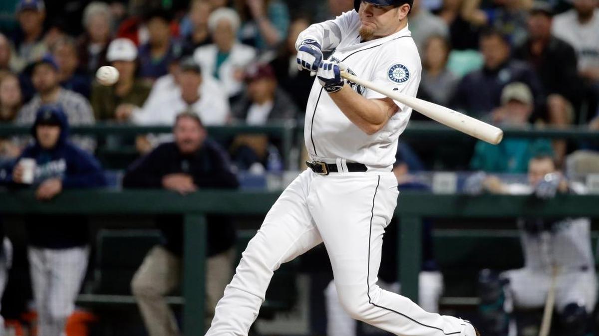 Seattle’s Adam Lind connects for a grand slam in the first inning Wednesday against the Texas Rangers. The Mariners led 8-0 before winning 8-3.
