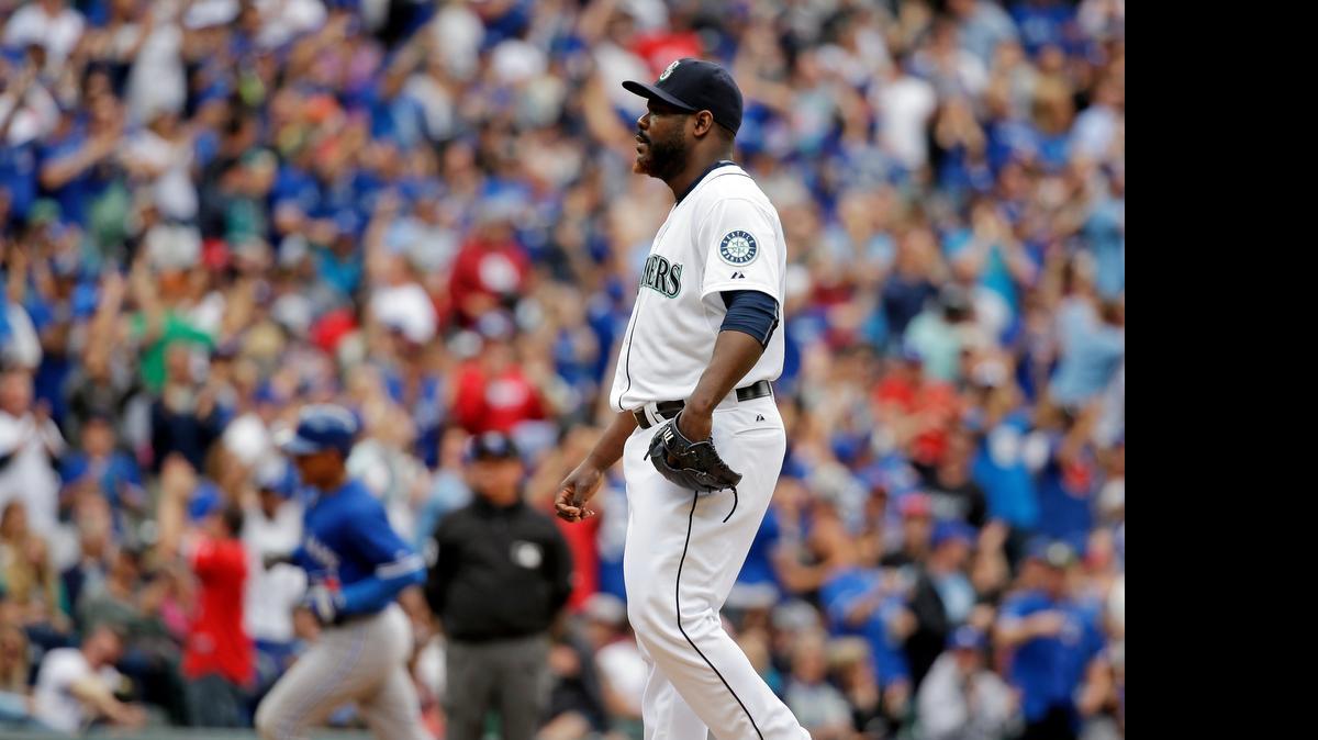
Seattle Mariners relief pitcher Fernando Rodney, right, waits on the mound as Toronto’s Ezequiel Carrera rounds the bases after hitting a two-run home run in the eighth inning Saturday at Safeco Field.
