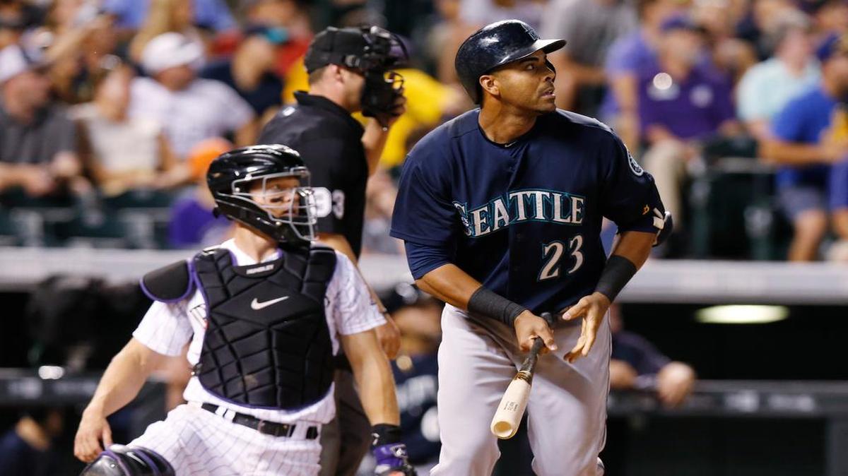 Seattle’s Nelson Cruz, right, watches his solo home run against the Colorado Rockies in Denver on Tuesday. 