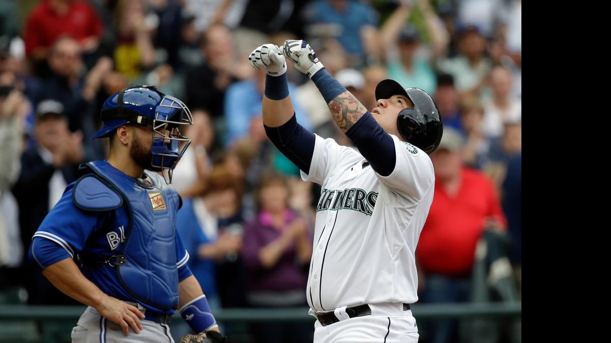 
Seattle Mariners backup catacher Jesus Sucre, right, celebrates as Toronto Blue Jays catcher Russell Martin waits for the next batter after Sucre's first career home run in the second inning Saturday at Safeco Field.

