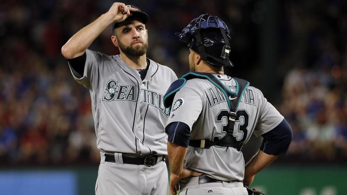 Seattle Mariners starting pitcher Nathan Karns, left, talks with catcher Chris Iannetta in the third inning against the Texas Rangers this past Saturday. Mariners starting pitching, which lost Felix Hernandez to the disabled list, has taken a pounding this past week.