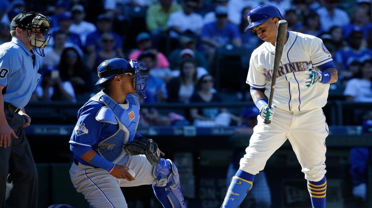Seattle Mariners' Leonys Martin, right, reacts after striking out seining as Kansas City Royals catcher Salvador Perez prepares to return the ball in the ninth inning of a baseball game, Sunday, May 1, 2016, in Seattle. The Royals beat the Mariners 4-1.