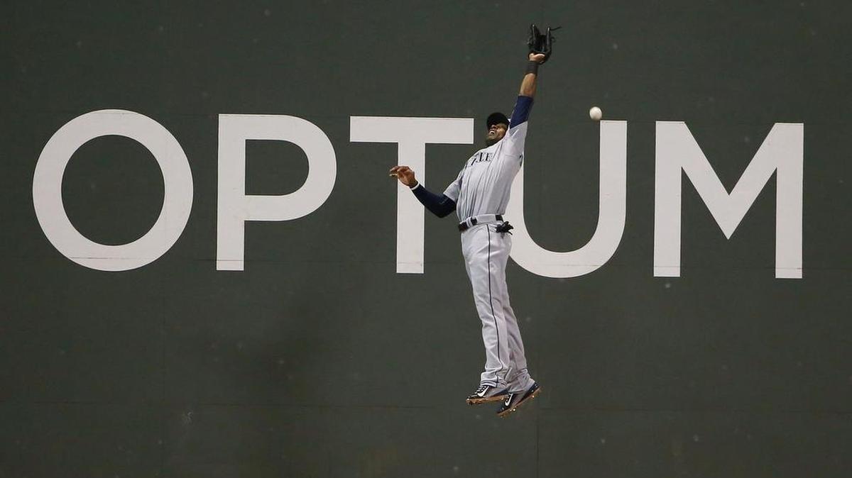 
Center fielder Austin Jackson, failing to catch a ball hit by Brock Holt of the Red Sox in Boston on Aug. 14, was traded by the Seattle Mariners to the Chicago Cubs on Monday. Jackson, a pending free agent, used a recent hot surge to raise his season batting average to .272.
