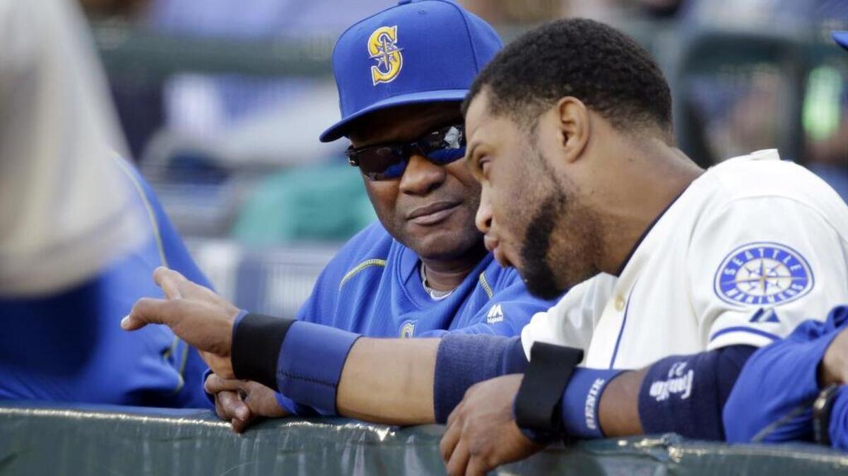 
Mariners manager Lloyd McClendon, left, talks with Robinson Cano Sunday at Safeco Field. McClendon said a 2-9 homestand early in the season was when the team got mired in a rut. 
