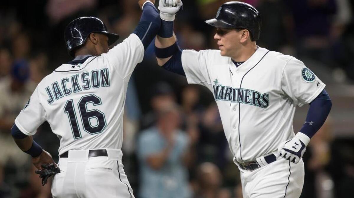 
Seattle’s Logan Morrison, right, is congratulated by teammate Austin Jackson after Morrison hit a two-run home run — on his 28th birthday — to score Jackson during the fourth inning against Oakland on Tuesday at Safeco Field
