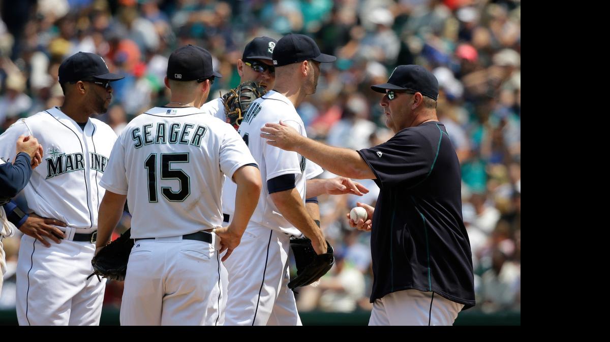 
Mariners starting pitcher J.A. Happ, second from right, is pulled in the fifth inning by bench coach Trent Jewett, right, during Seattle’s 5-4 loss to Detroit on Wednesday at Safeco Field.
