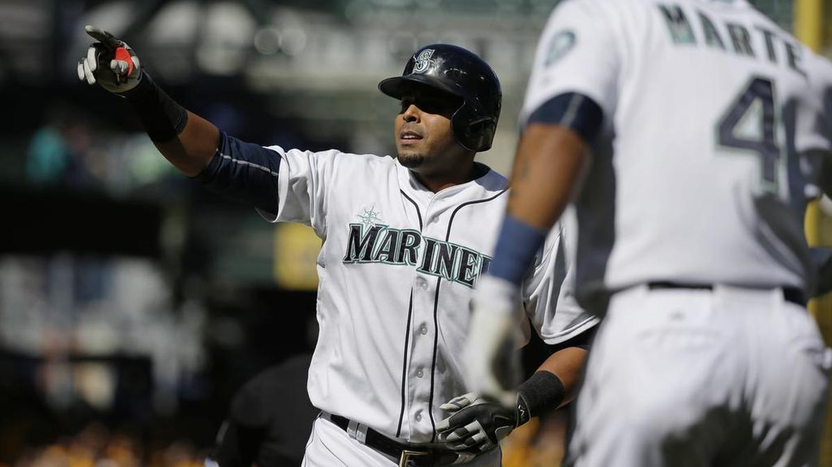 
Seattle Mariners' Nelson Cruz reacts as he reaches home plate after hitting a two-run home run that also scored Ketel Marte (4) in the seventh inning of a baseball game against the Texas Rangers, Thursday, Sept. 10, 2015, in Seattle. The Mariners won 5-0.

