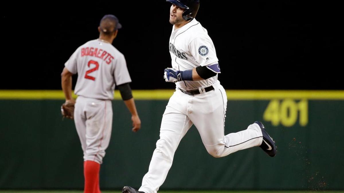 Mariners catcher Mike Zunino rounds the bases past Boston Red Sox shortstop Xander Bogaerts (2) on his home run during the sixth inning Wednesday. Thursday’s game against the Red Sox was in progress at press time.