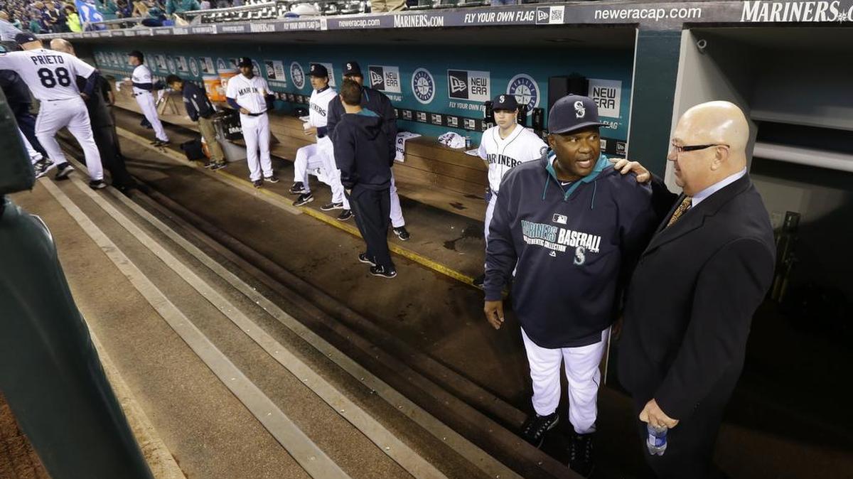 
Seattle Mariners general manager Jack Zduriencik, right, talks with new manager Lloyd McClendon, second from right, in the dugout, Tuesday, April 8, 2014, just before the start of the Mariners' home opener baseball game against the Los Angeles Angels in Seattle.
