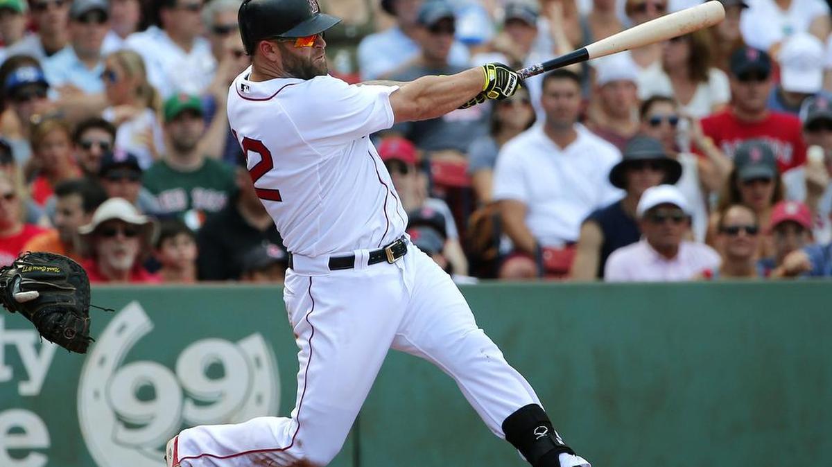 Boston’s Mike Napoli swings during a game in early August at Fenway Park. Napoli, along with Adam Lind, are two players the Mariners are looking at to hopefully bolster their roster.