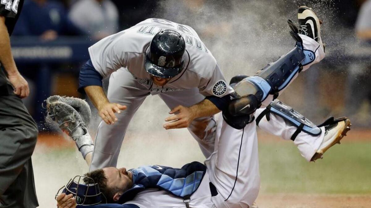 Chris Iannetta (top) was thrown out the plate in the seventh inning when Tampa Bay catcher Curt Casali held the throw from left fielder Jaff Decker after a collision.