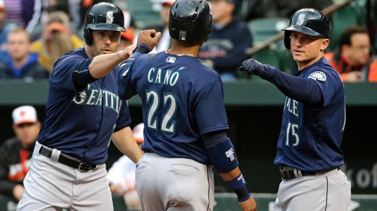 Seattle Mariners’ Robinson Cano celebrates with teammates Seth Smith, left, and Kyle Seager after he and Smith scored on a single by Nelson Cruz in the first inning of a baseball game against the Baltimore Orioles in Baltimore, Tuesday, May 17, 2016.