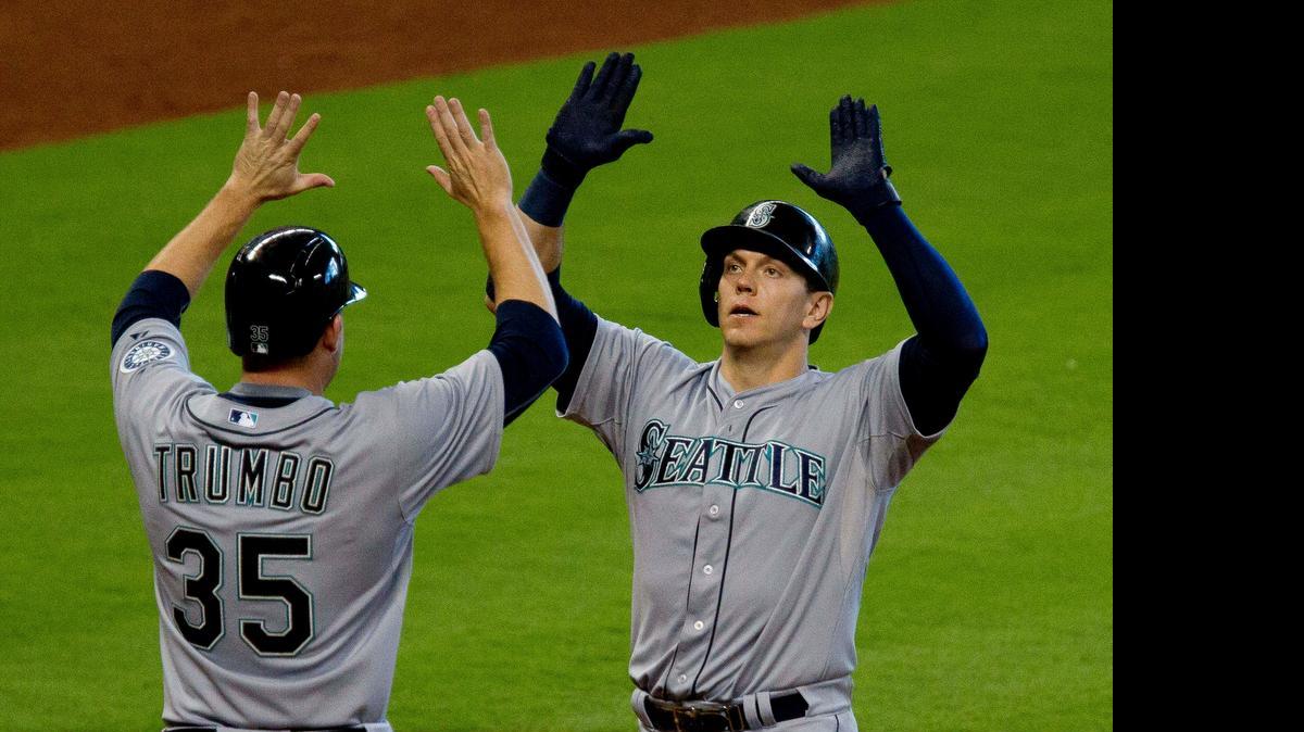 
The Seattle Mariners’ Logan Morrison celebrates with teammate Mark Trumbo after hitting his second home run Saturday against the Houston Astros. 
