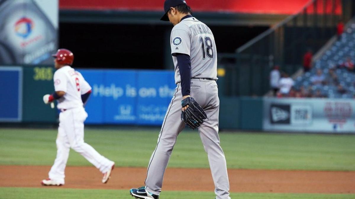 Seattle Mariners pitcher Hisashi Iwakuma returns to the mound after walking Los Angeles Angels’ Mike Trout – advancing Yunel Escobar, background, to second base – during the first inning of a baseball game in Anaheim, Calif., on Thursday, Aug. 18, 2016.