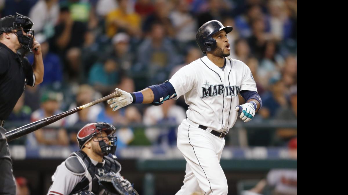 
The Mariners’ Robinson Cano hits a solo home run on a pitch from Robbie Ray of the Diamondbacks on Monday. 
