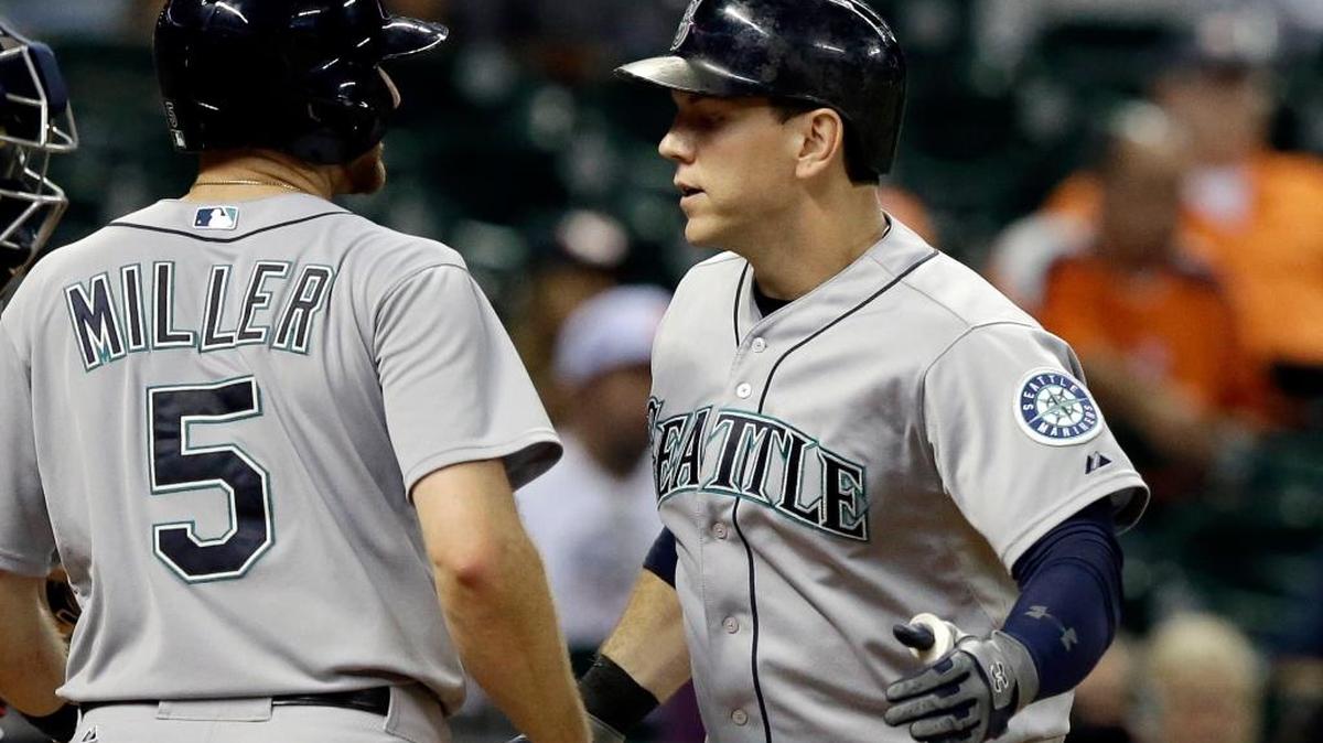 
Seattle pinch hitter Logan Morrison, right, is welcomed home by Brad Miller (5) after hitting a two-run home run to give the Mariners the lead 7-5. 
