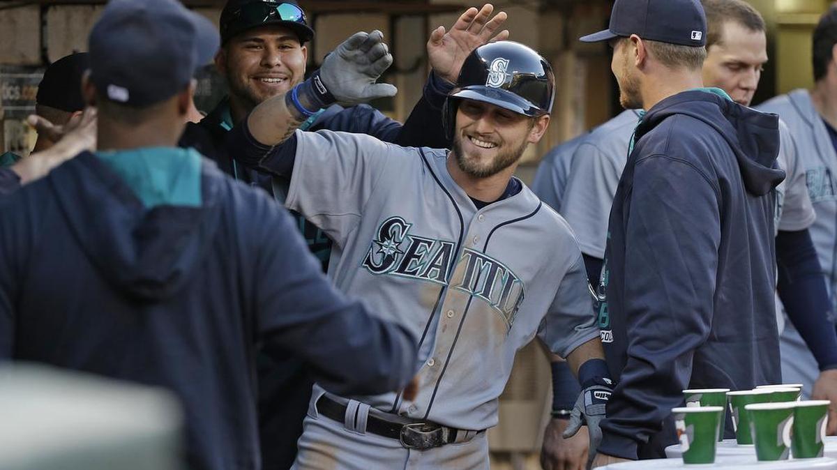 
Mariners rookie Shawn O'Malley is greeted in the dugout after hitting his first major league home run.
