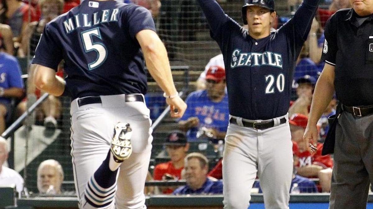 Seattle Mariners shortstop Brad Miller (5) and first baseman Logan Morrison (20) — who both scored on the same play in September against the Texas Rangers in Arlington, Texas — were traded Thursday to Tampa Bay along with relief pitcher Danny Farquhar.