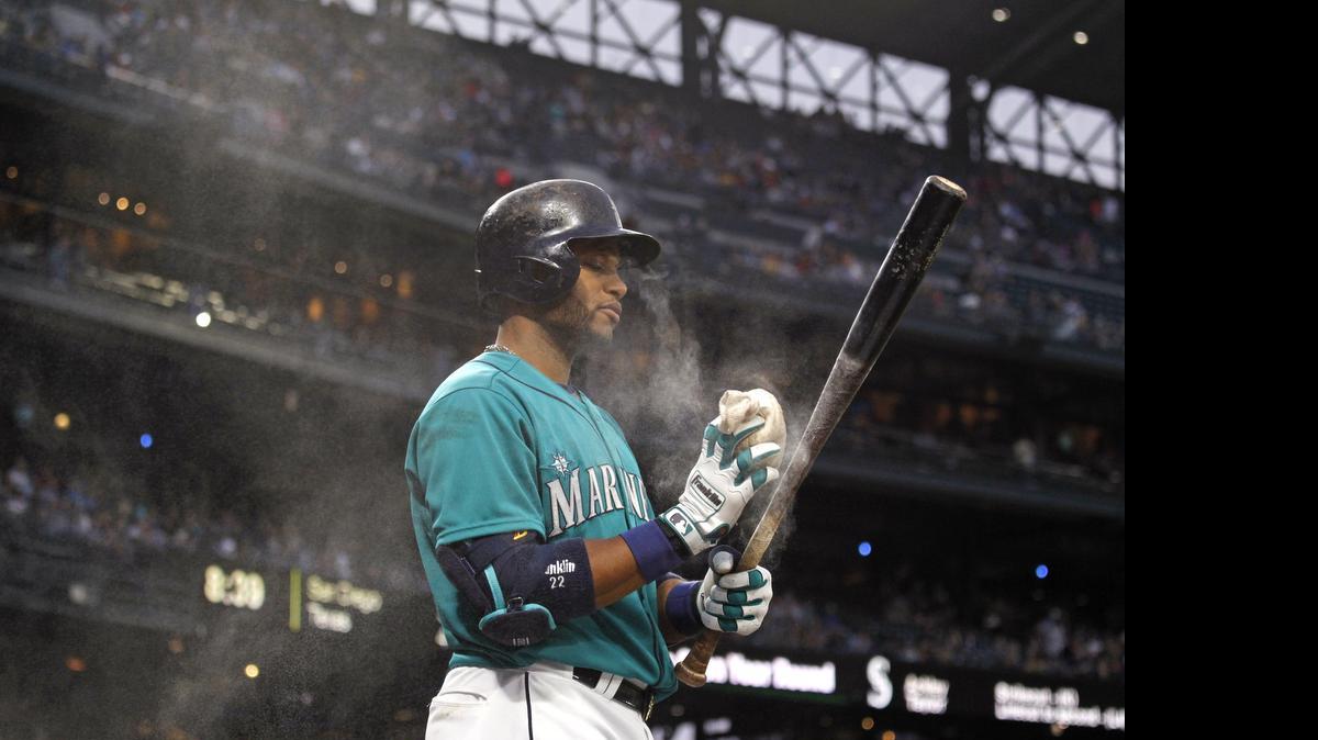 
Robinson Cano uses rosin on his bat during a Friday’s game against the Los Angeles Angels. Cano, a three-time participant in the Home Run Derby, won the 2011 event by hitting 32 homers over three rounds — but finished last with a zero the following year.
