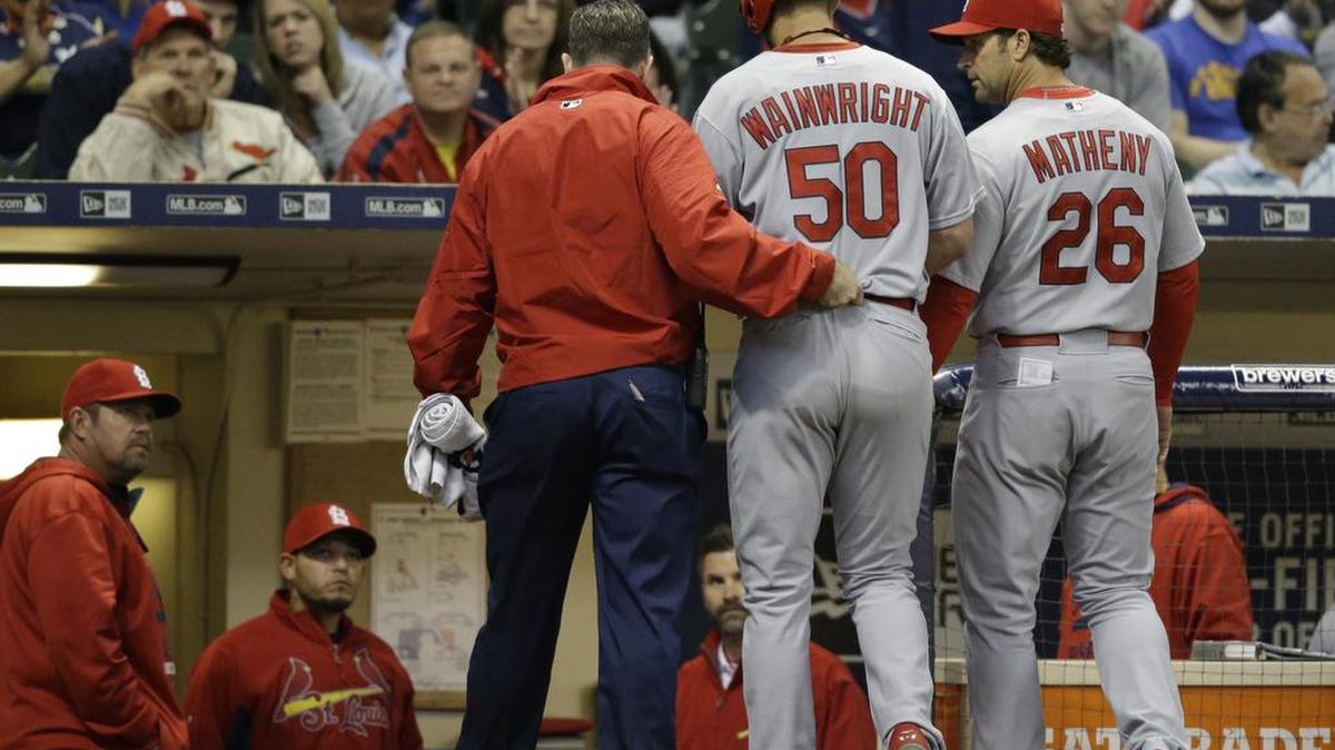 St. Louis pitcher Adam Wainwright (50) ruptured his Achilles tendon while batting against Milwaukee on April 25. The injury cost him most of the season. National League owners are starting to warm to the idea of using the designated hitter like the American League.