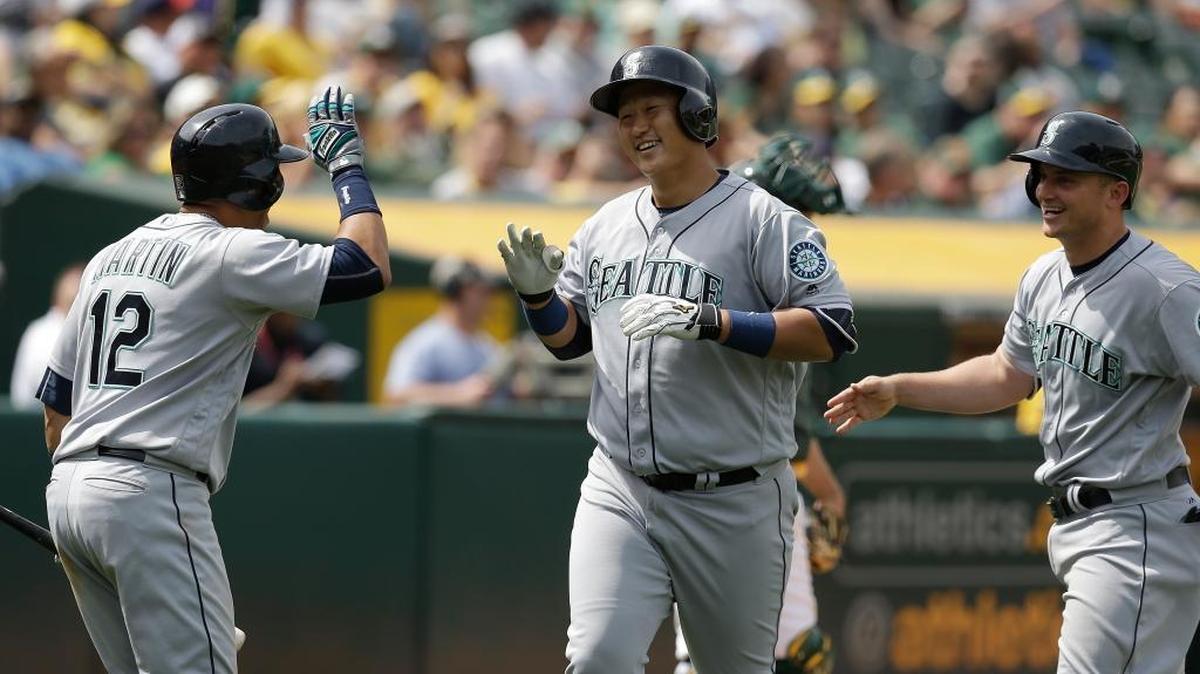 Seattle Mariners’ Dae-Ho Lee, center, is congratulated by Leonys Martin (12) and Kyle Seager, right, after hitting a two run home run off Oakland’s John Axford in the seventh inning of a baseball game Wednesday, May 4, 2016, in Oakland, Calif.