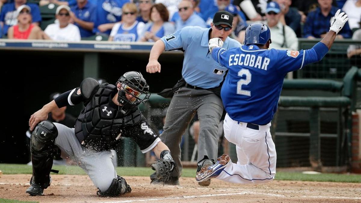Kansas City’s Alcides Escobar beats the tag by Chicago White Sox catcher Rob Brantly to score on a sacrifice fly hit by Eric Hosmer on Saturday, March 5, in Surprise, Ariz.