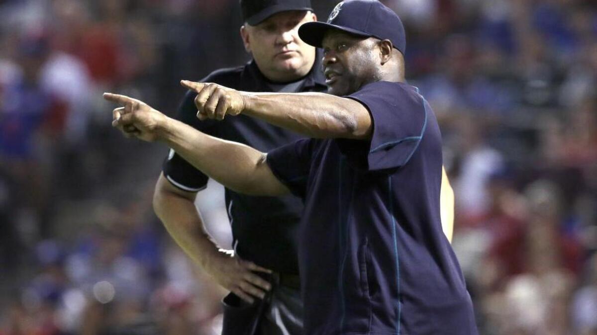 
Seattle Mariners manager Lloyd McClendon, right, argues a call with umpire Jeff Nelson in the fourth inning Sept. 18 against the Texas Rangers in Arlington. McClendon spoke with new GM Jerry Dipoto for a couple of hours Monday and said of the meeting, “It was great.”
