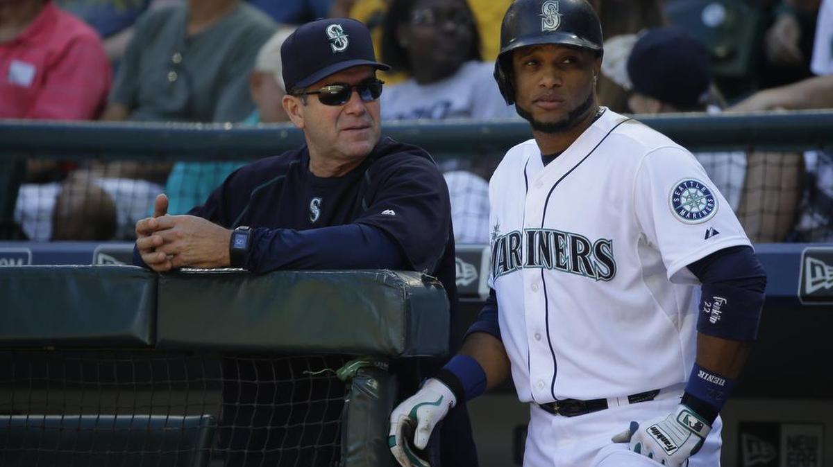 
Seattle Mariners’ Robinson Cano, right, stands with Mariners hitting coach Edgar Martinez during a September baseball game in Seattle. New Mariners general manager Jerry Dipoto says Edgar Martinez showed clearly how invested he was in role as hitting coach and has opted to keep him on staff for another year. 
