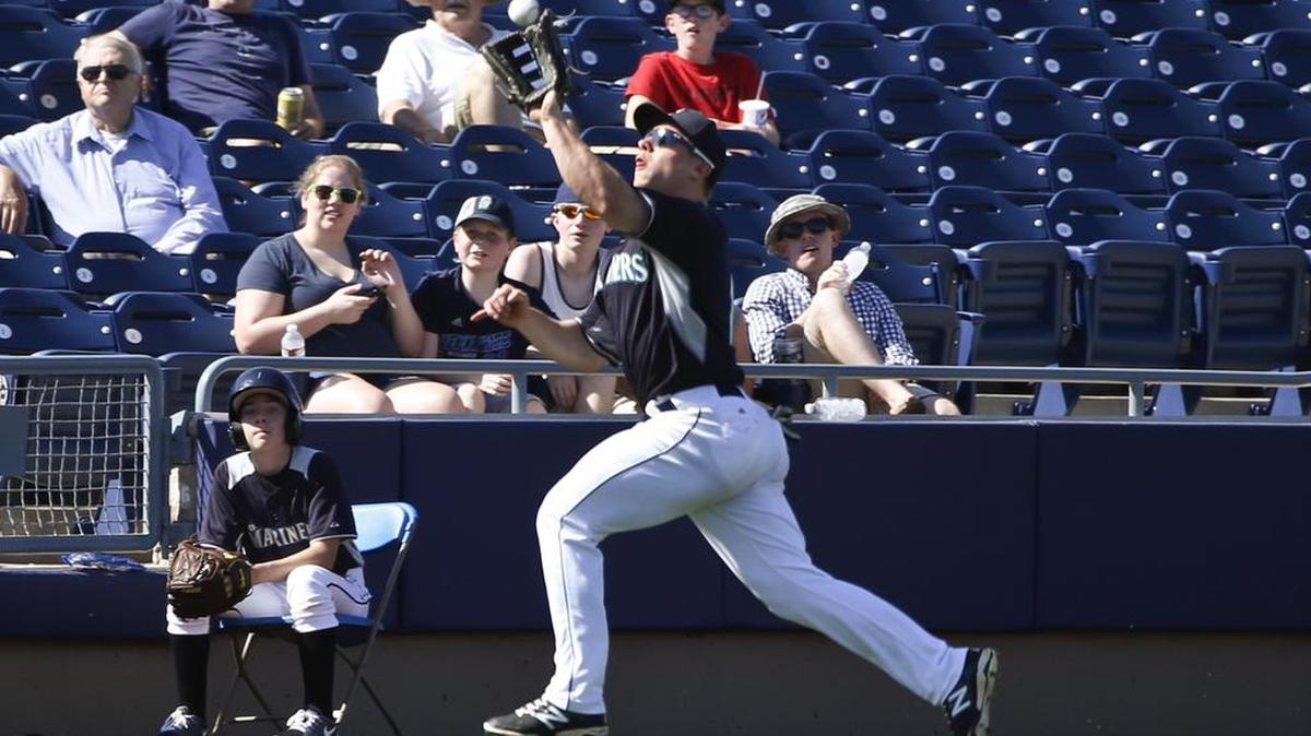 Seattle Mariners leftfielder Tyler O’Neill makes a running catch of a ball hit by Kansas City Royals’ Erik Kratz in the eighth inning of a spring training baseball game Thursday, March 26, 2015, in Peoria, Ariz.