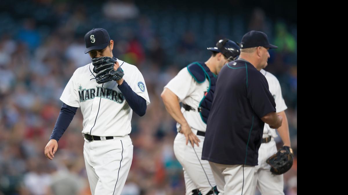 
Mariners starter Hisashi Iwakuma walks off the field after being removed in the sixth inning against the Detroit Tigers on Monday night.
