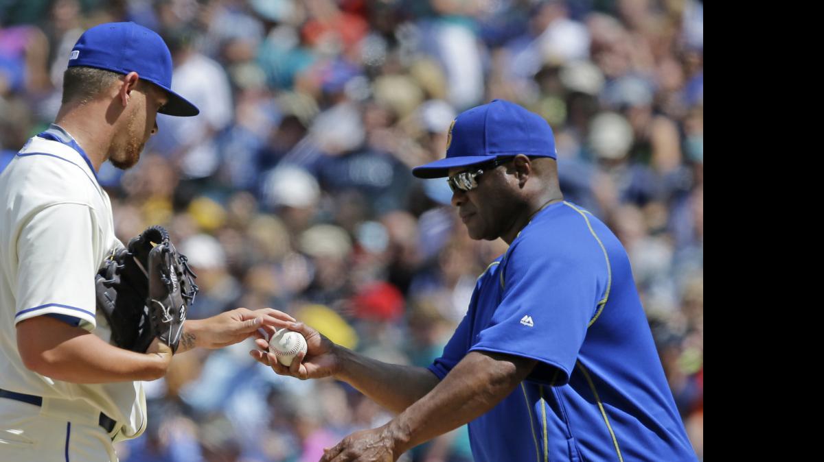 
Seattle Mariners manager Lloyd McClendon, right, removing pitcher David Rollins from the game in the sixth inning against the Los Angeles Angels on Sunday, vows changes will be made for the second half of the season. “We’ve got to get better. ... We have to change things,” McClendon says.
