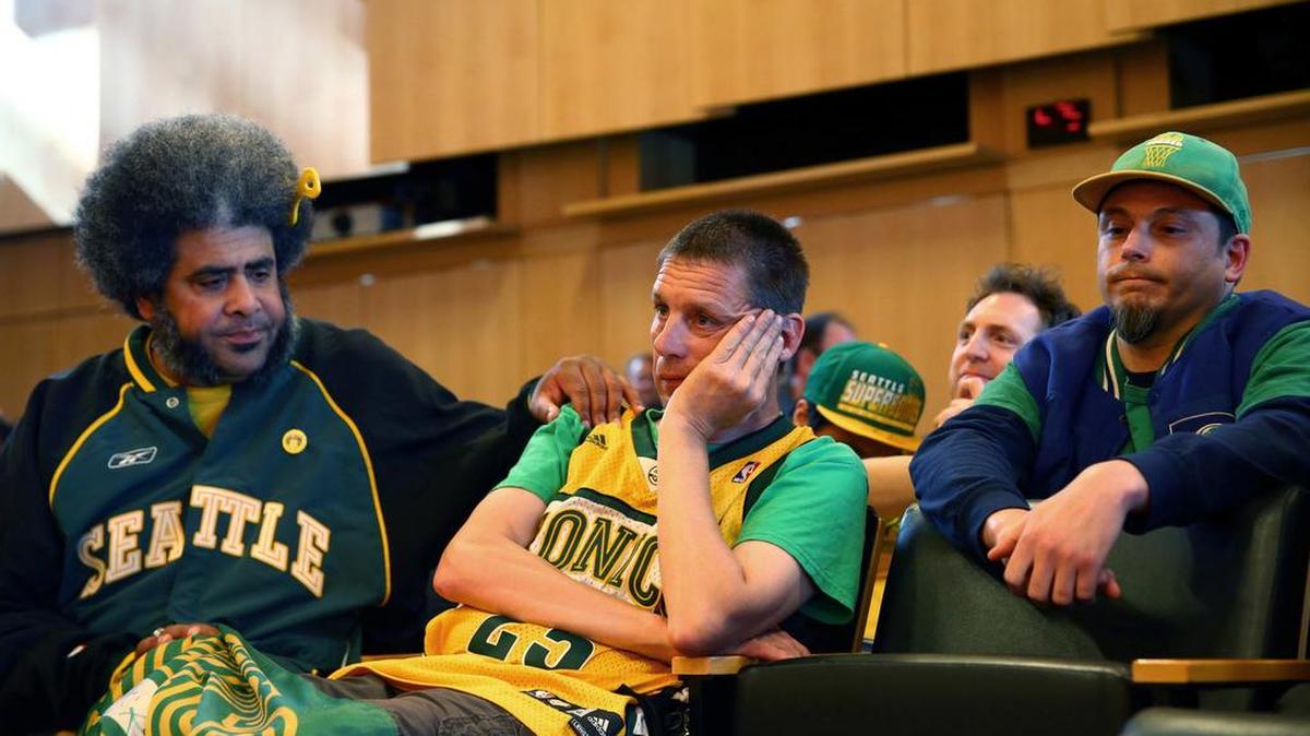 Seattle SuperSonics fans Kris "Sonics Guy" Brannon, left, Kenneth Knutsen, center, and Jason Billingsley react to the Seattle City Council's 5-4 no vote against a "street vacation" vacating stretch of road where investor Chris Hansen hopes to eventually build an arena that could house an NBA and NHL team.