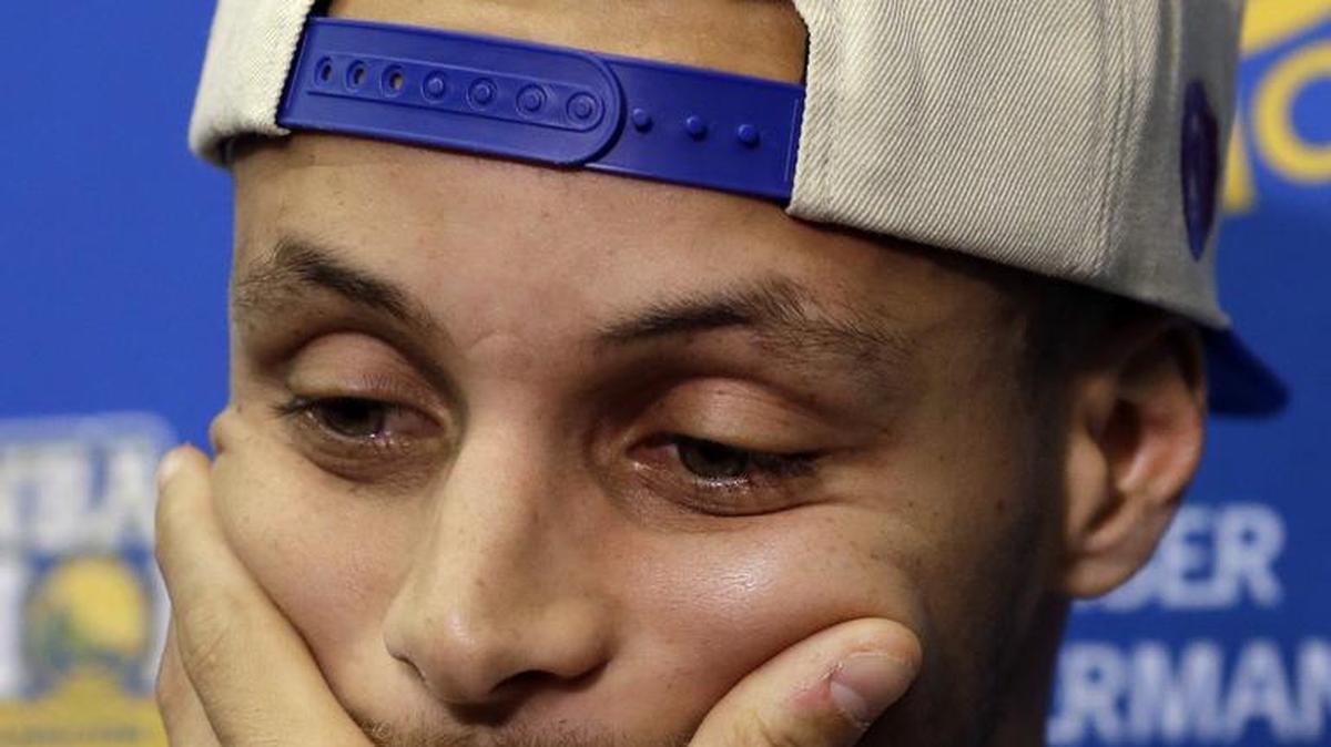 Golden State’s Stephen Curry listens to a question Monday, the day after the Cleveland Cavaliers defeated the Warriors to win the NBA Finals.