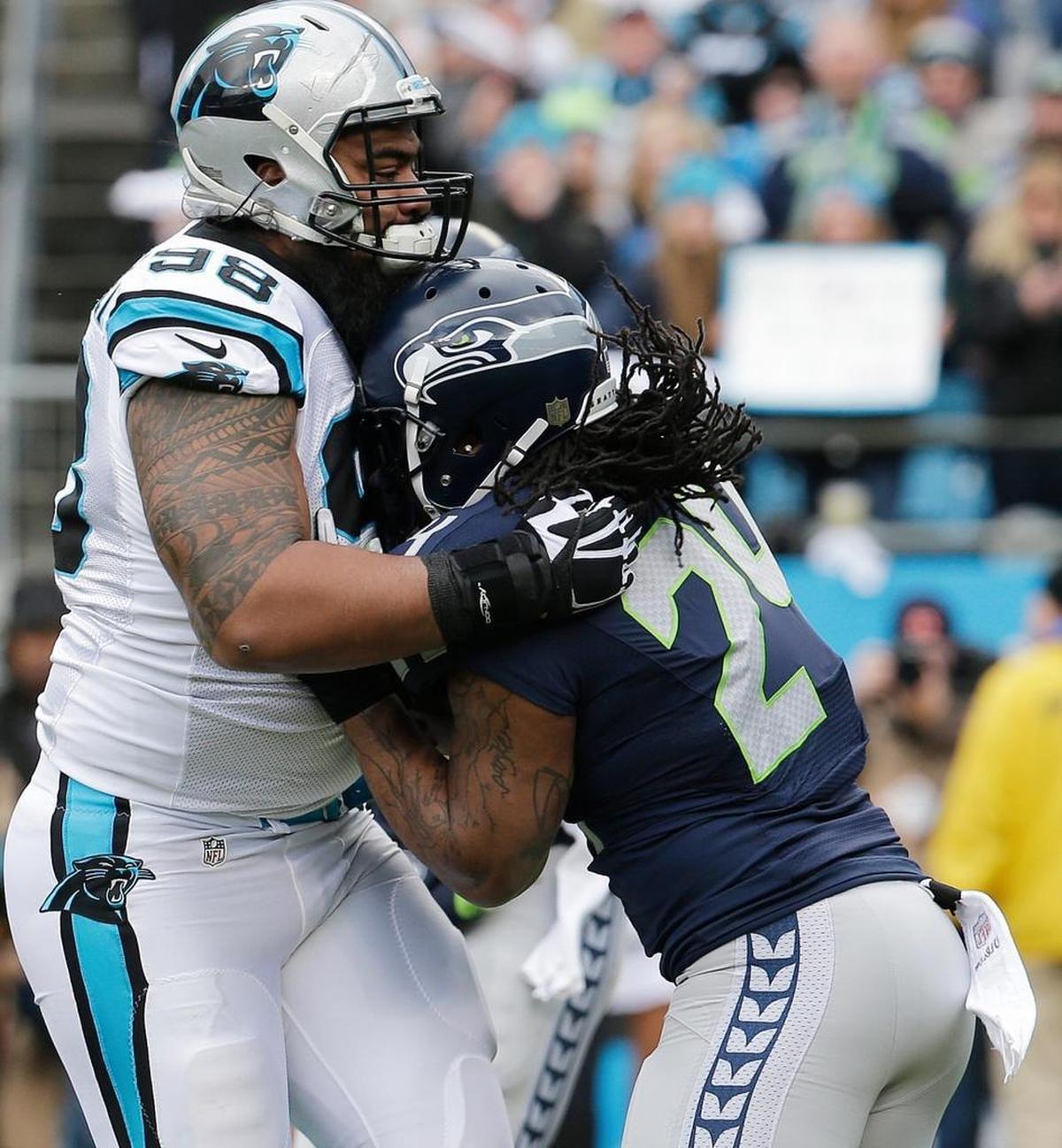 Carolina Panthers defensive tackle Star Lotulelei (98) stops Seattle Seahawks running back Marshawn Lynch (24) during the first half of an NFL divisional playoff football game, Sunday, Jan. 17, 2016, in Charlotte, N.C.