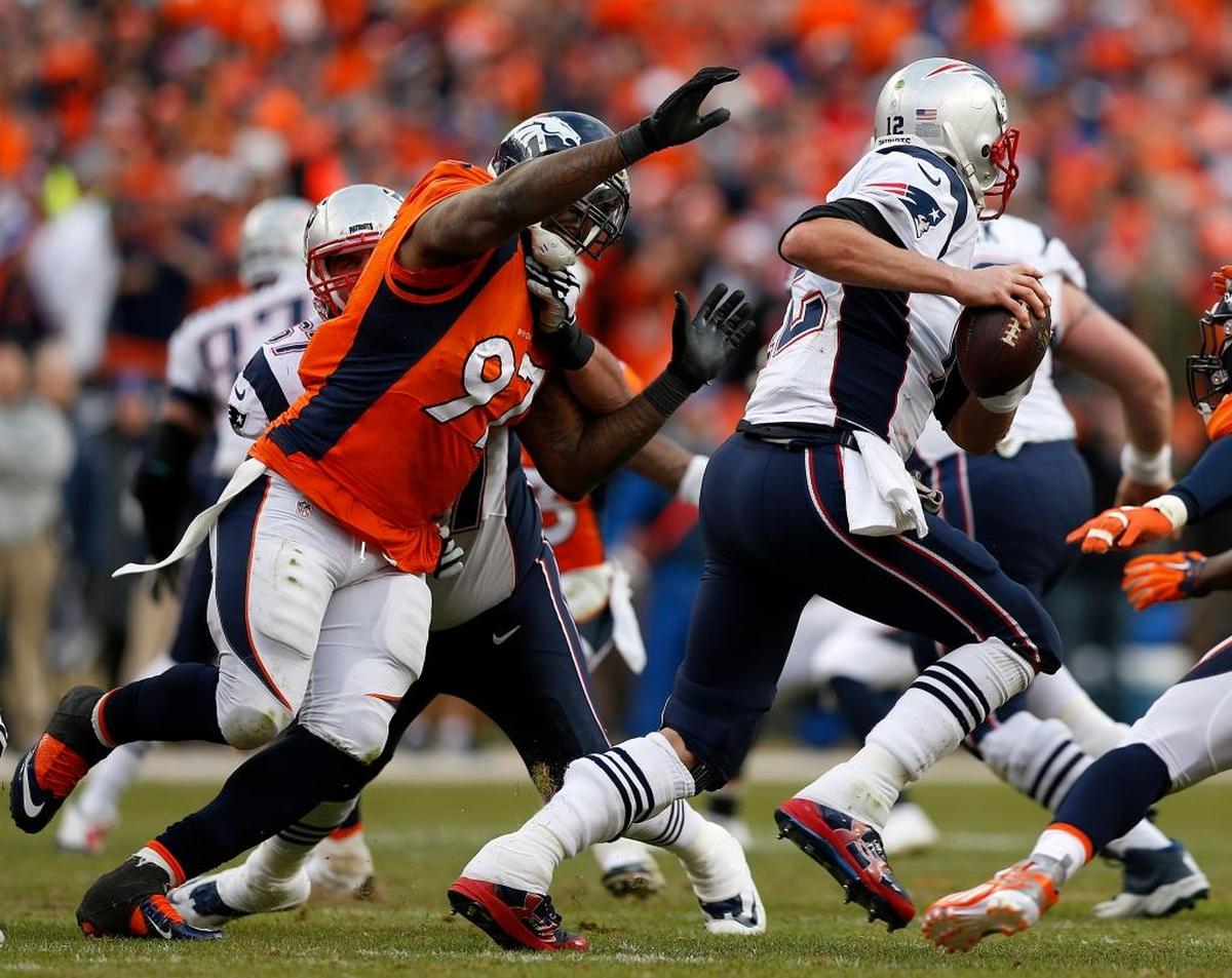 New England Patriots quarterback Tom Brady is chased down by Denver Broncos defensive end Malik Jackson (97) during the second half of the NFL football AFC Championship game between the Denver Broncos and the New England Patriots, Sunday, Jan. 24, 2016, in Denver.