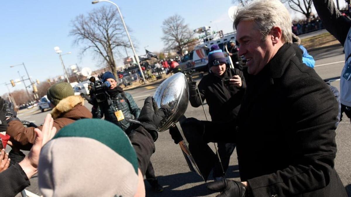 A fan reaches out to touch the Lombardi Trophy carried by Philadelphia Eagles coach Doug Pederson during the Super Bowl LII victory parade, Thursday, Feb 8, 2018, in Philadelphia. Peterson was born in Bellingham and grew up in Ferndale, graduating from Ferndale High School in 1986.