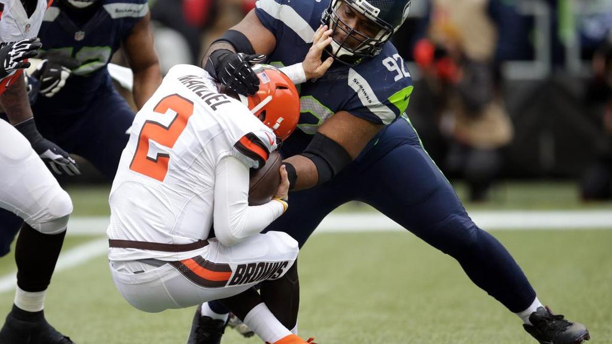 Seattle Seahawks’ Brandon Mebane (92) brings down Cleveland Browns quarterback Johnny Manziel (2) in the first half of a game Dec. 20 in Seattle.