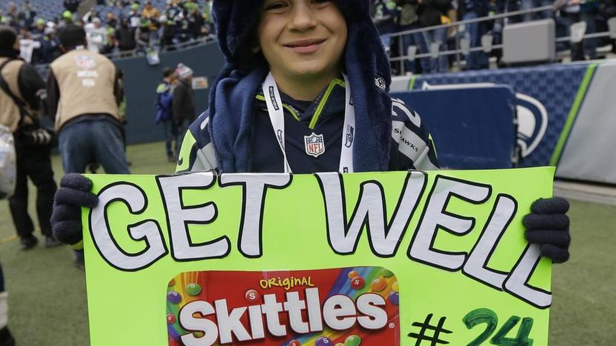 A young Seahawks fans holds up a sign wishing well injured Seahawks' running back Marshawn Lynch before a game against the Steelers on Nov. 29.